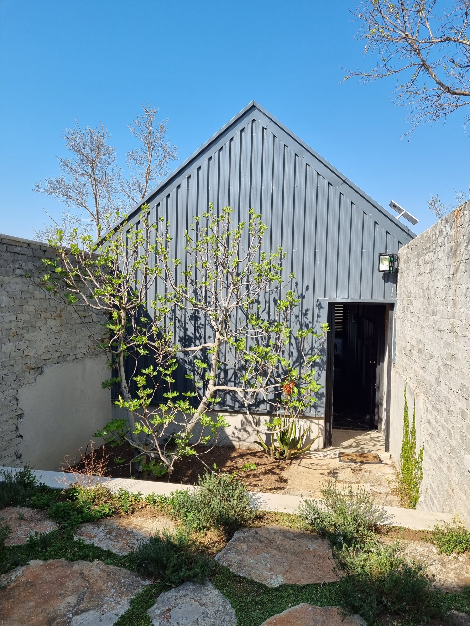 Steel-clad gable and garden