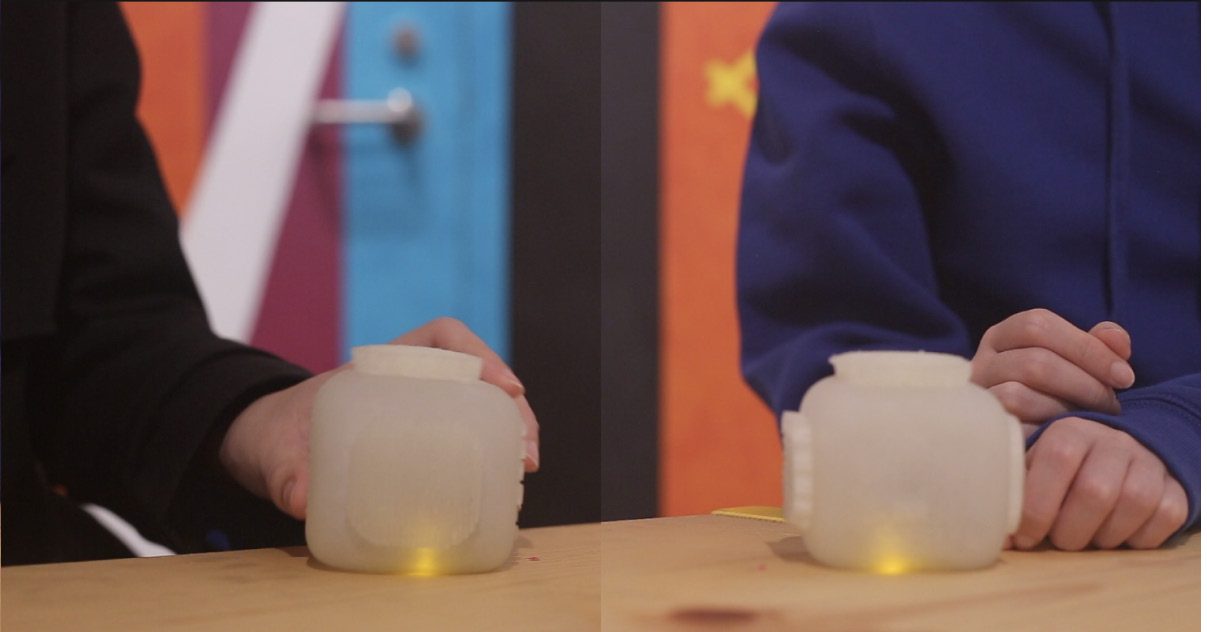 Hands holding two linked cubes